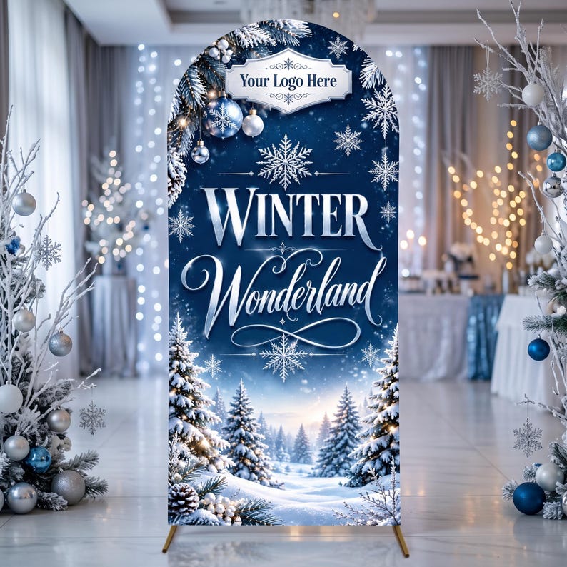 May include: An arched backdrop display featuring a deep blue winter scene with snow-covered pine trees, snowflakes, and hanging ornaments. The text reads "Your Logo Here" at the top and "WINTER Wonderland" in large, elegant white and silver lettering.