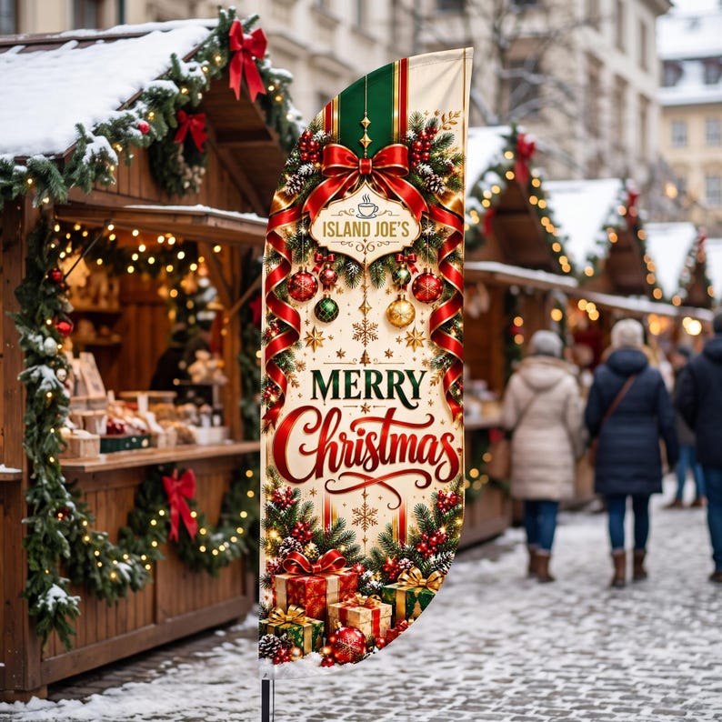 May include: A vertical feather flag featuring a cream background with red ribbons, green pine branches, ornaments, and gift boxes. The text reads ISLAND JOE'S and MERRY CHRISTMAS in red and green lettering, centred on the fabric banner.